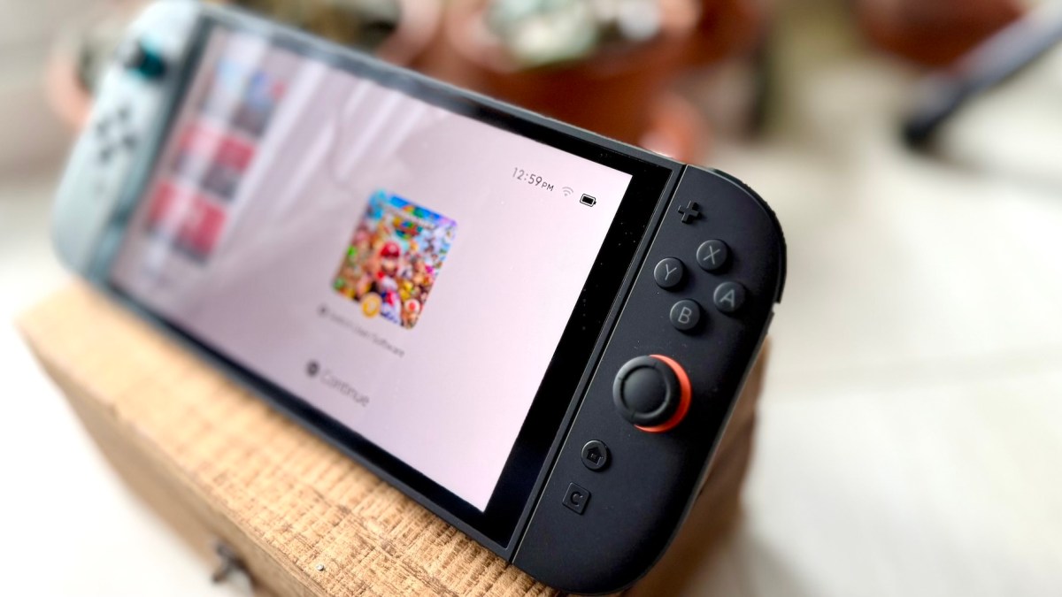 A black gaming device with buttons and a white screen